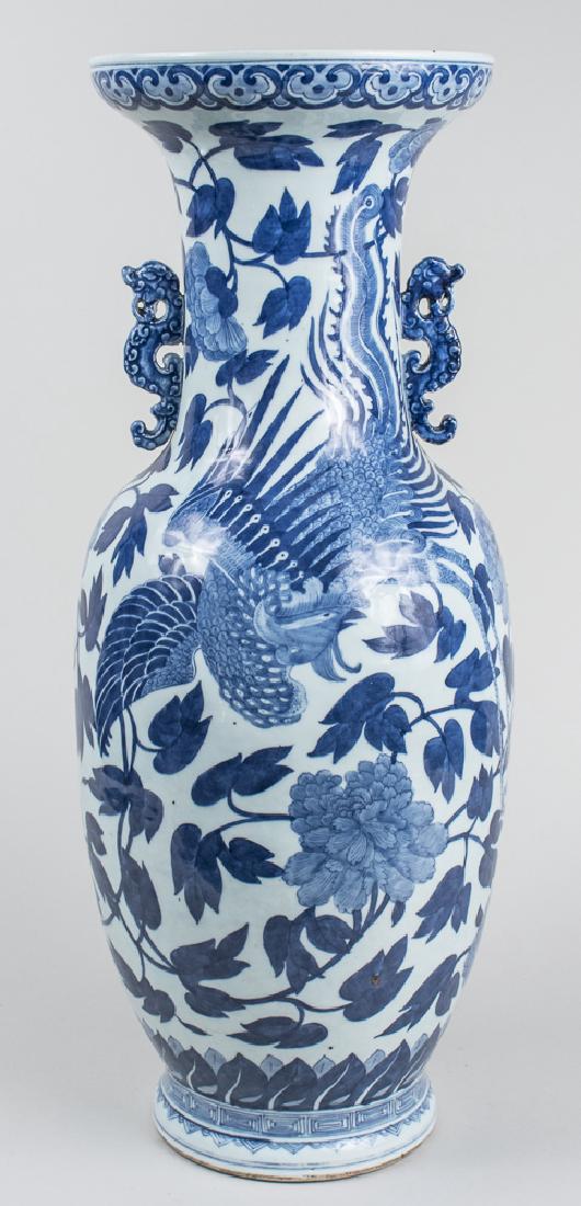 Chinese Blue and White Porcelain Vase: Flared rim, waisted neck with two dragon handles, ovoid body and ring foot, allover floral and dragon decoration. Height 26 inches. Notice to bidders: Condition reports and additional photographs are