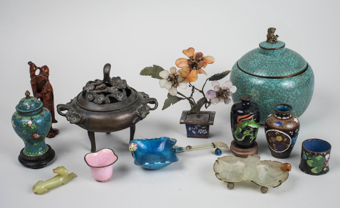 Group of Chinese Table Decorations: Including a censor, two covered jars, a carved hardstone flower arrangement, two cloisonne vases, a brush washer, etc. Largest, height 7 1/2 inches. Notice to bidders: Condition reports and additional