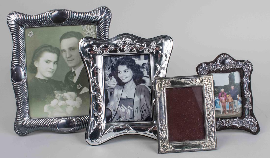 Four Silver Plated Picture Frames: Various shapes and sizes. Largest, holds 8 x 10 inch photo. Notice to bidders: Condition reports and additional photographs are provided by request as a courtesy to our clients, as such any condition 