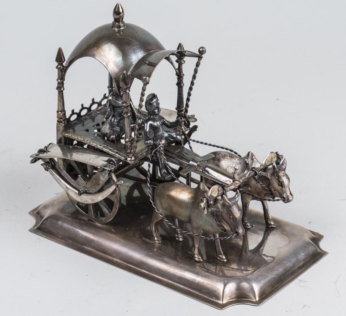 Portuguese Silver Ox and Cart *: Two Brahma bulls pulling a covered cart with driver and dignitary or holy man seated within. Height 6 1/2 inches, length 71/4 inches, width 5 inches, 812 grams. Notice to bidders: Condition reports an