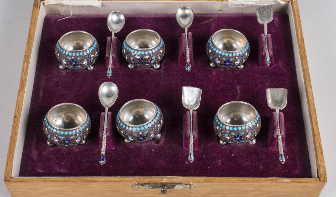 Russian Silver and Enamel Salt Set: Boxed set of six varicoloured enamel decorated salt cellars with spoons, circular with ball feet, maker's mark illegible. Diameter 1 1/4 inches. Notice to bidders: Condition reports and additional pho