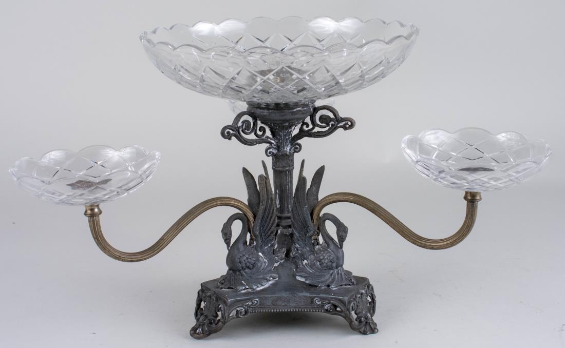 Epergne: Three scrolled arms centering a circular bowl. Height 11 inches. Notice to bidders: Condition reports and additional photographs are provided by request as a courtesy to our clients, as such any condi