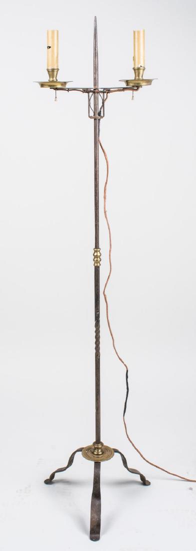 Floor Lamp: Two candle lights now electrified, on a wrought iron support and tripartite base with three scrolled legs. Height 58 1/2 inches. Provenance: Deaccessioned from the Van Cortlandt House Museum collectio