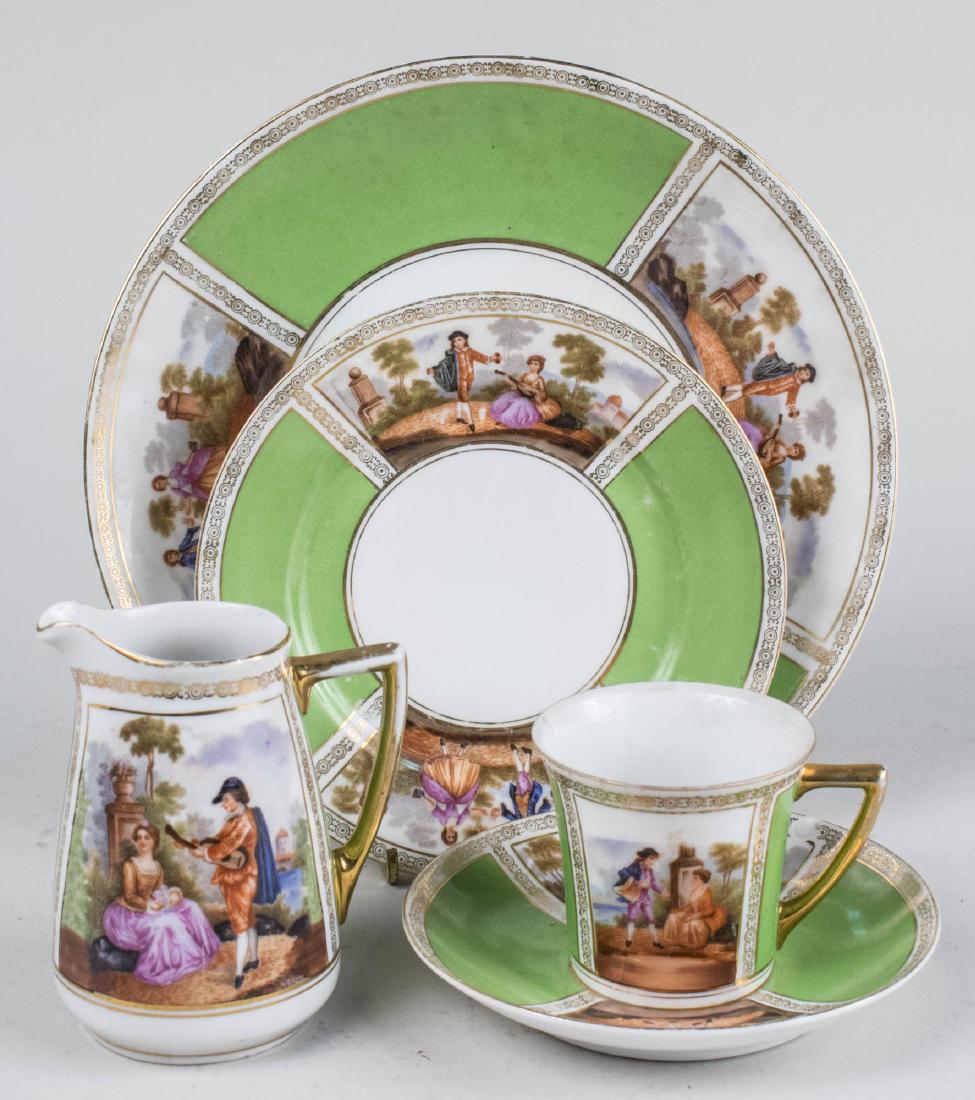 Epaig Czech Porcelain Dessert Service: Approximately thirty six pieces, green and white border with courting couple and gilt decoration, comprising two serving plates, twelve dessert plates, ten cups, ten saucers, a creamer and a waste bow