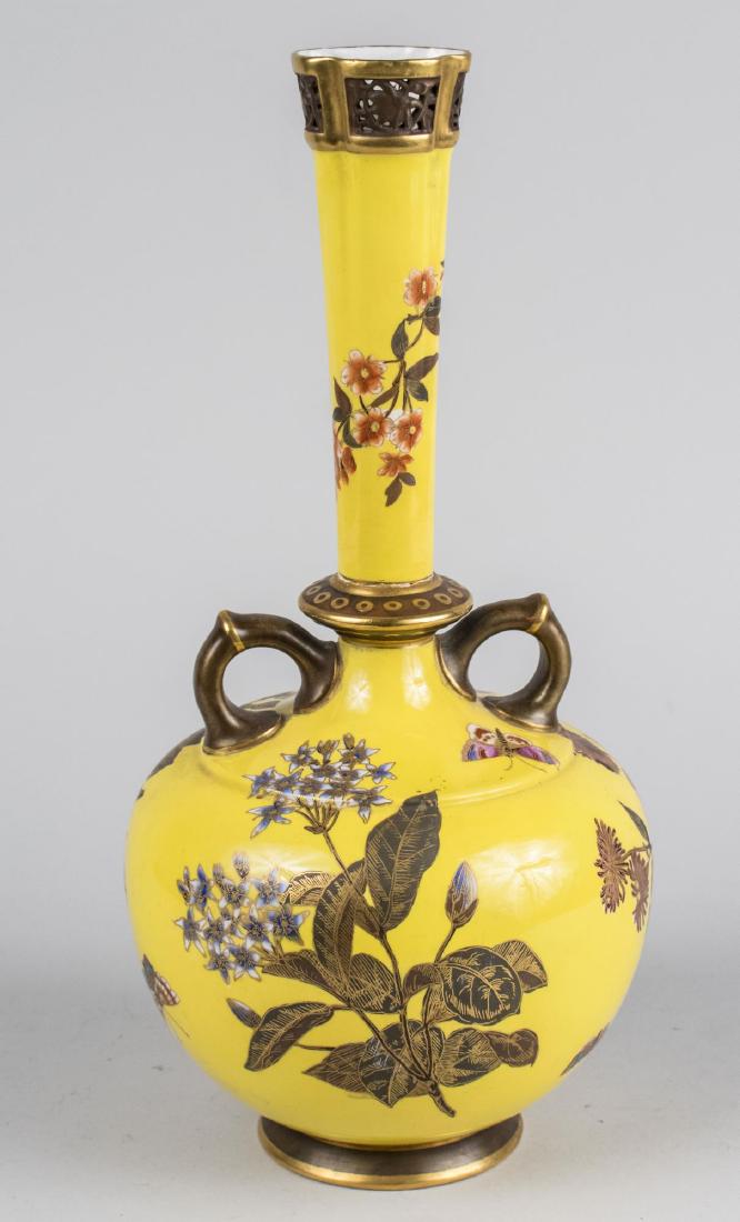Royal Worcester Vase: Bottle form with pierced rim, and two handles. Height 15 1/4 inches. Notice to bidders: Condition reports and additional photographs are provided by request as a courtesy to our clients, as such any c