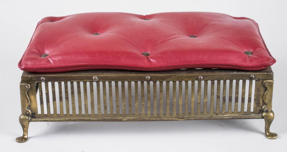Brass Footstool: Button tufted red simulated leather on a brass base. Height 6 1/2 inches, width 19 1/2 inches, depth 11 inches. Notice to bidders: Condition reports and additional photographs are provided by request 