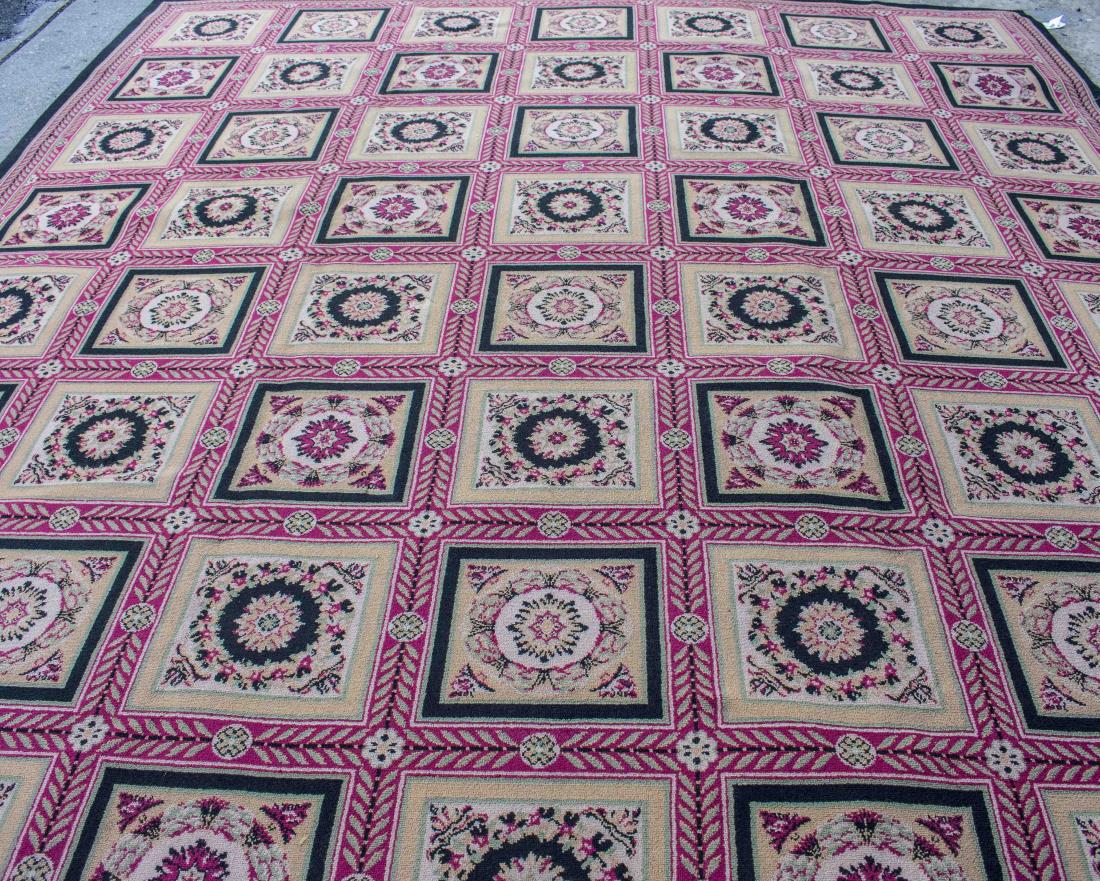 Stark Machine Made Custom Carpet: Allover checker board pattern of floral reserves with black and tan accents, within red borders with laurel decoration. 12 feet 10 inches x 11 feet 5 inches. Notice to bidders: Condition reports and a