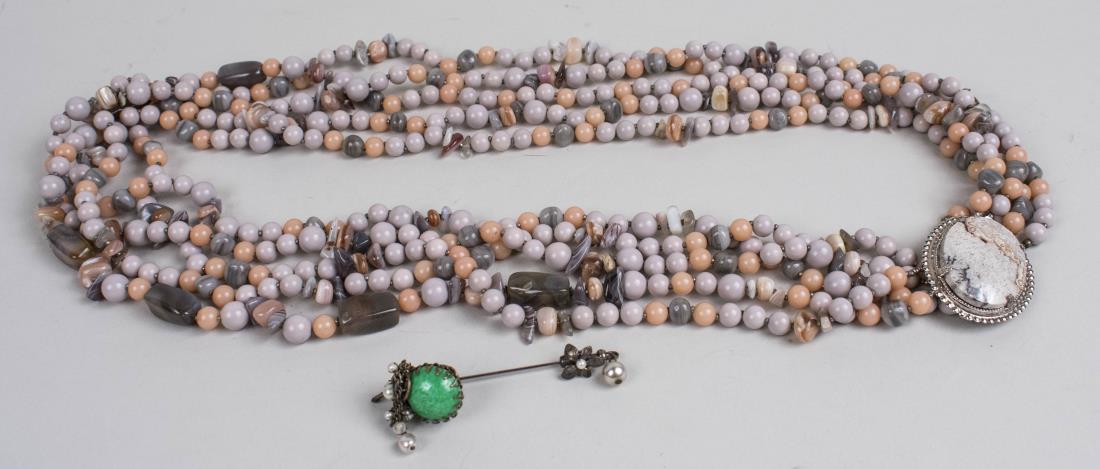 Miriam Haskell Bead Necklace & Stickpin: A five strand agate bead necklace with signed clasp, together with a simulated jade stickpin. Necklace length 30 inches. Notice to bidders: Condition reports and additional photographs are provided by