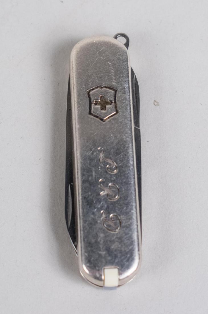 Tiffany & Co. Sterling Silver Swiss Army Knife: With scissors, nail file, tweezers and toothpick, monogrammed, L.R.D., with original Tiffany & Co. pouch and box. Length 2 1/4 inches. Notice to bidders: Condition reports and additional photographs a