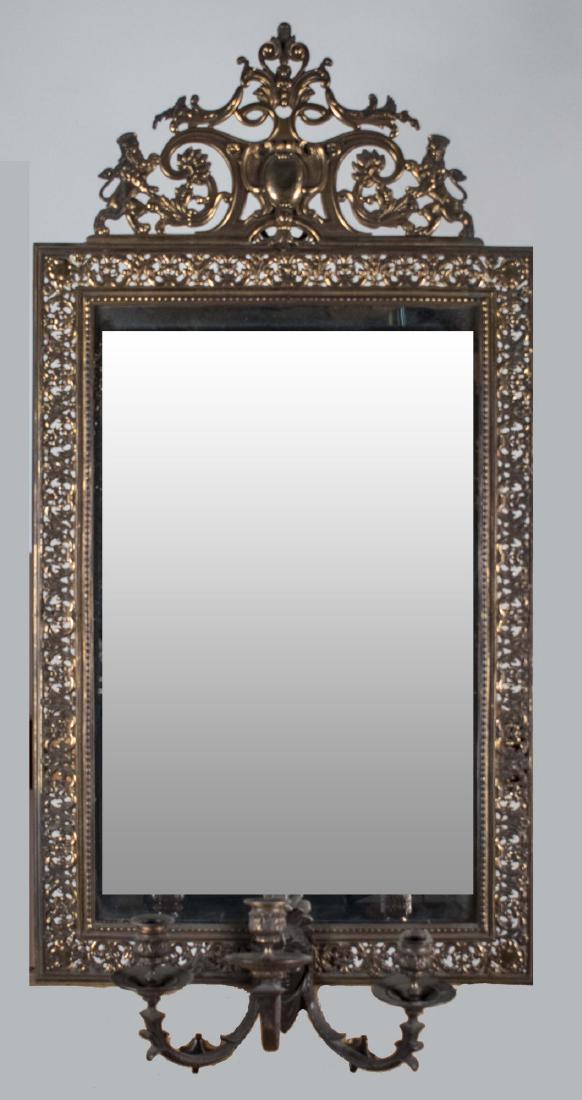 Girandole Mirror: Reticulated brass frame with scroll, floral and rampant lion decorated pediment, issuing three scroll arms ending in candle lights, rectangular mirror plate. 36 1/2 x 18 inches. Notice to bidders: Con