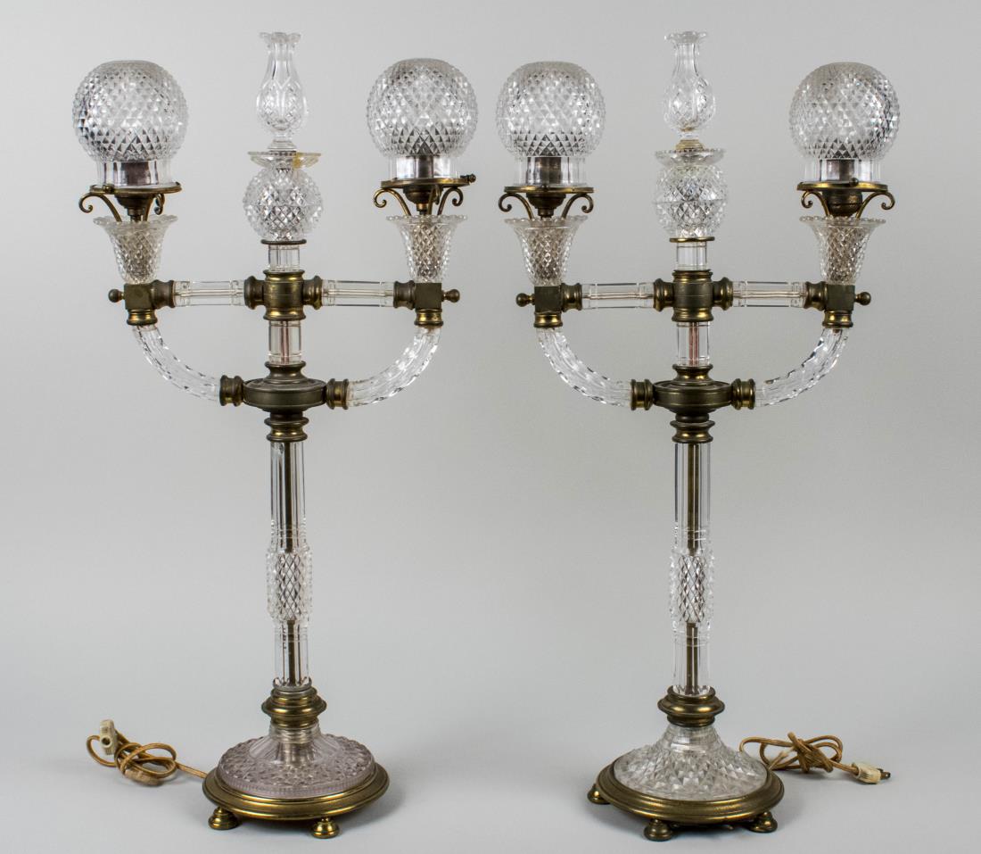 Pair of Cut Glass Lamps: Two light lamps, with diamond cut glass globular shades. Height 30 inches. Notice to bidders: Condition reports and additional photographs are provided by request as a courtesy to our clients, as such