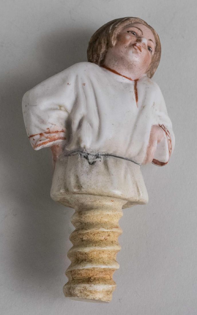 Gardner Russian Porcelain Vodka Bottle Stopper *: Bisque porcelain figure of a peasant with his head tilted on his left shoulder and a smile on his face. Height 4 inches. Notice to bidders: Condition reports and additional photographs are provided by