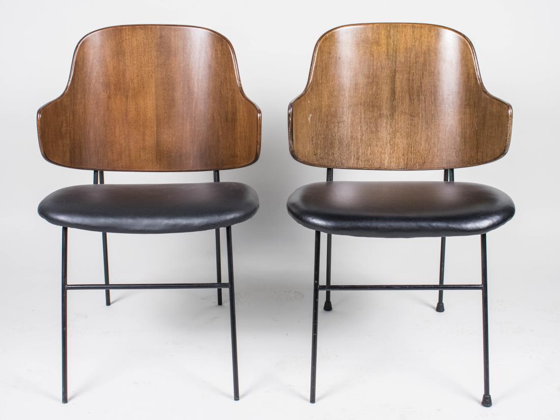 Pair of Ib Kofod-Larsen Penguin Chairs: Each with bent wood back and black leatherette upholstered seat, on a black painted tubular metal frame. Height 32 1/2 inches, width 21 1/2 inches, depth 21 inches. Notice to bidders: Condition report