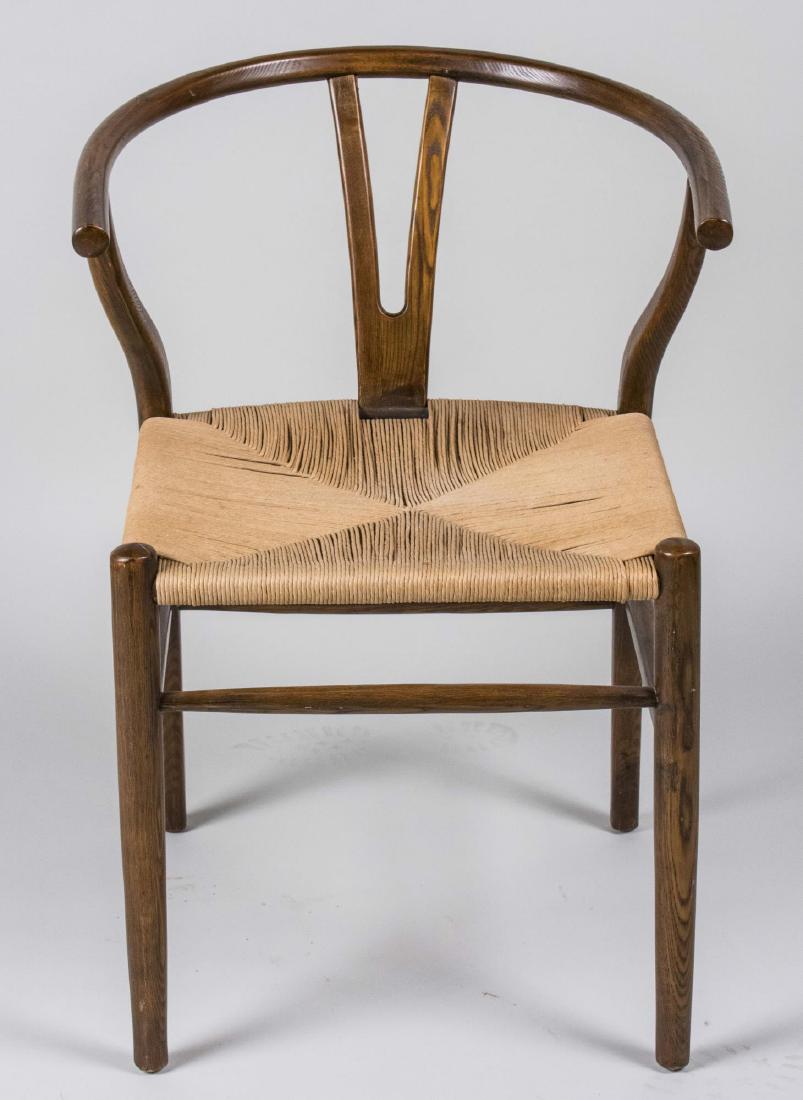 Hans Wegner Wishbone Chair: Rush seat chair. Height 31 inches, width 22 inches, depth 21 inches. Notice to bidders: Condition reports and additional photographs are provided by request as a courtesy to our clients, as such any c