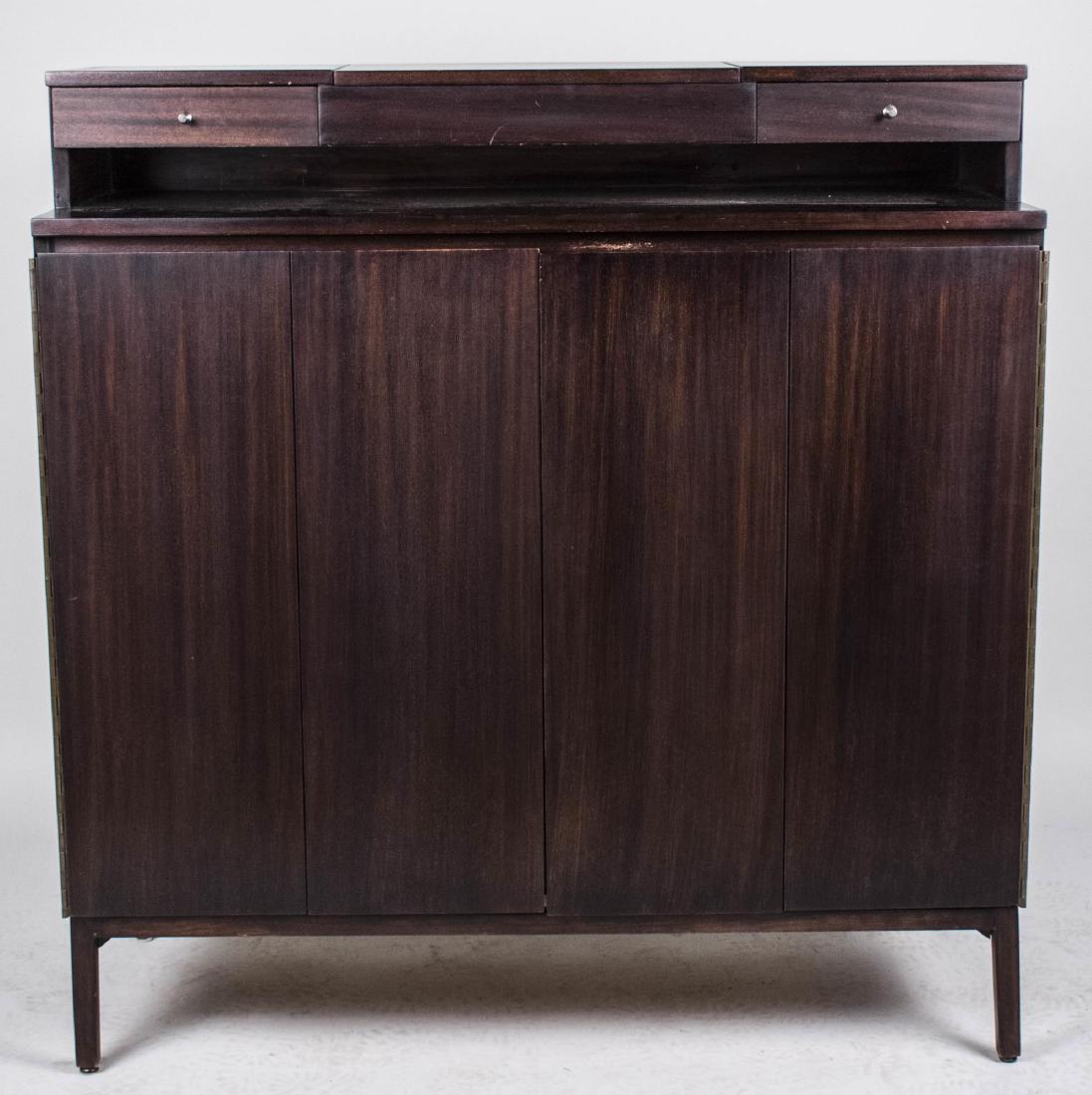 Paul McCobb for Calvin Gentleman's Dresser: Rectangular set back top with a lift top storage bin with mirror, flanked by two short drawers, above a cabinet with two folding doors opening to drawers and open shelves. Height 50 1/2 inches, width