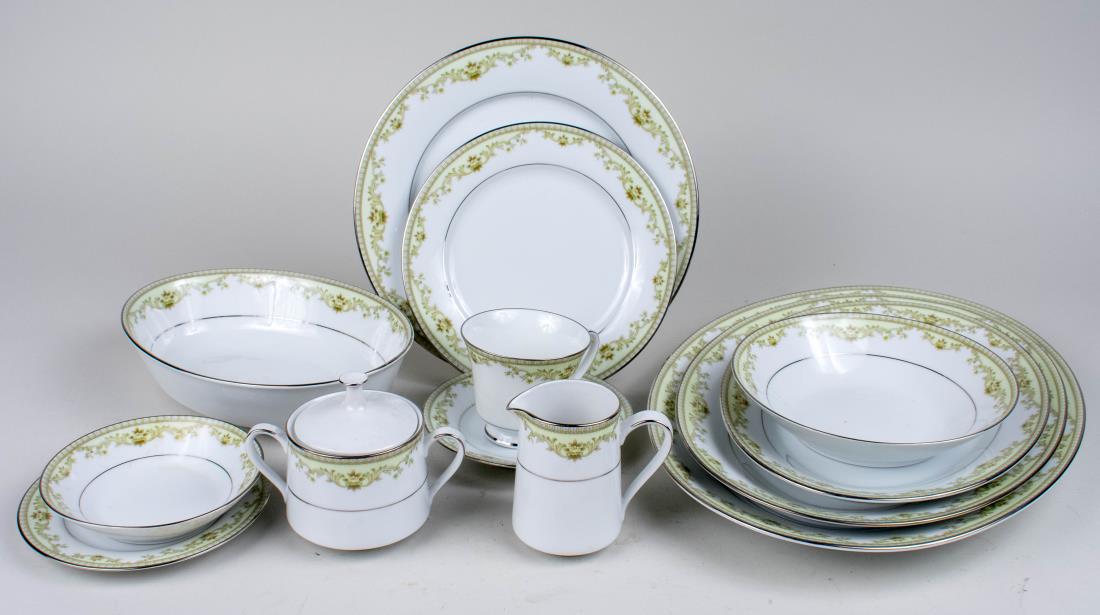 Noritake Porcelain Dinner Service: Approximately ninety six pieces, Raleigh pattern, comprising twelve dinner plates, twelve salad plates, twelve bread plates, twelve soup bowls, twelve fruit bowls, twelve cups, twelve saucers, two cre