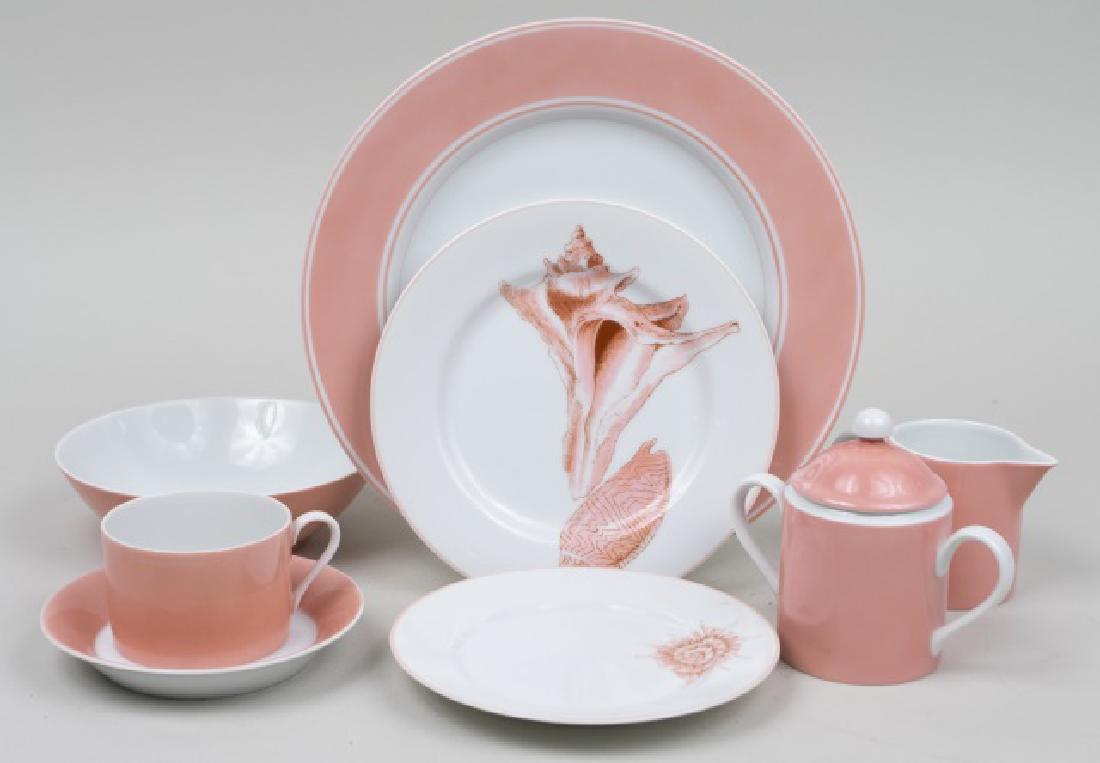 Fitz and Floyd Porcelain Dinner Service: Approximately eighty one pieces, Coquille pattern, comprising seventeen dinner plates, twelve salad plates, fifteen bread plates, twelve bowls, eleven cups, creamer and sugar bowl. Dinner plate, diame