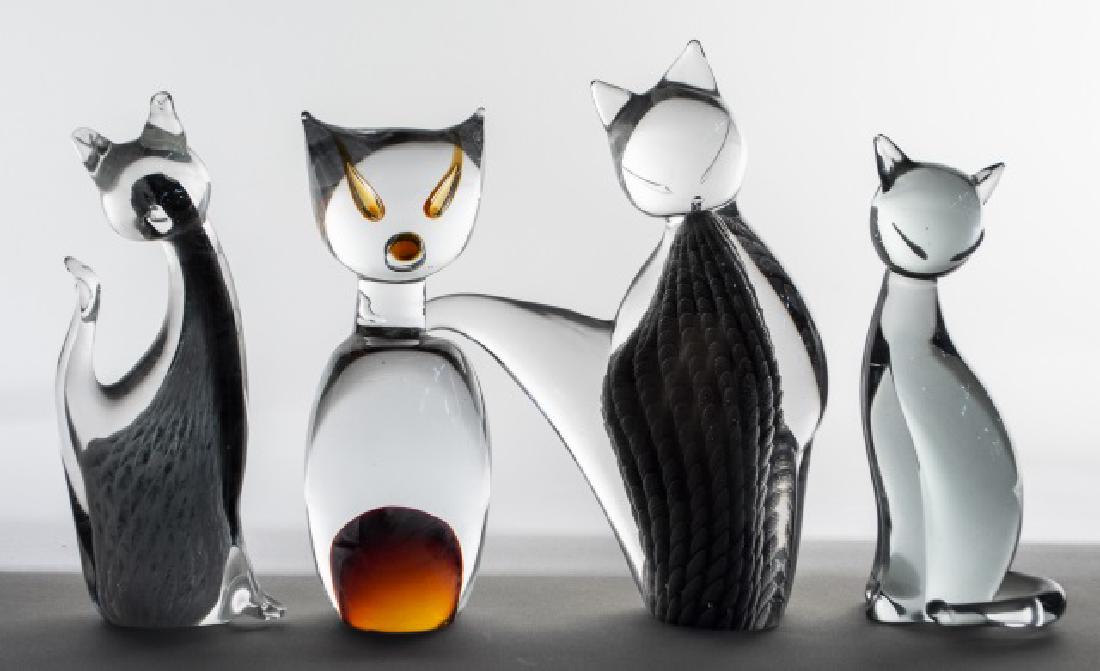 Four Art Glass Cat Figures: One signed illegibly. Tallest, height 10 inches. Notice to bidders: Condition reports and additional photographs are provided by request as a courtesy to our clients, as such any condition report is o