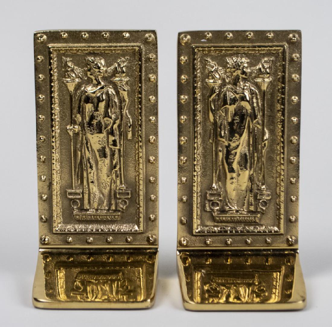 Pair of Brass Bookends: Designed as the front doors of the Library of Congress. Height 8 inches. Notice to bidders: Condition reports and additional photographs are provided by request as a courtesy to our clients, as such a