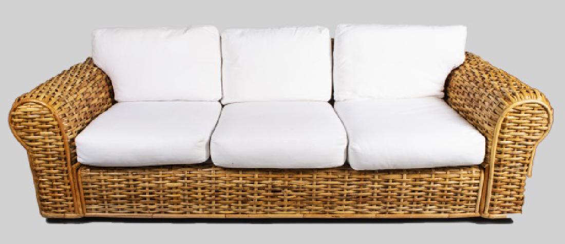 Ralph Lauren Rattan Sofa: Three seat sofa with white cushions. Height 30 inches, width 94 inches, depth 38 inches. Notice to bidders: Condition reports and additional photographs are provided by request as a courtesy to our cl