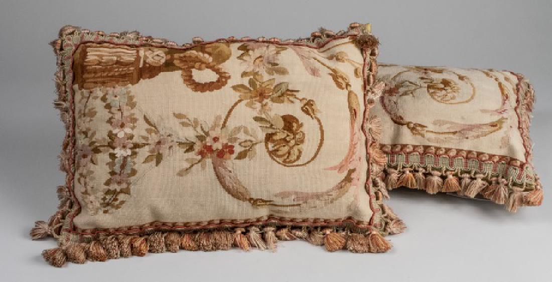 Pair of Aubusson Pillows: Floral decoration, accented with a fringed edge. Notice to bidders: Condition reports and additional photographs are provided by request as a courtesy to our clients, as such any condition report is o