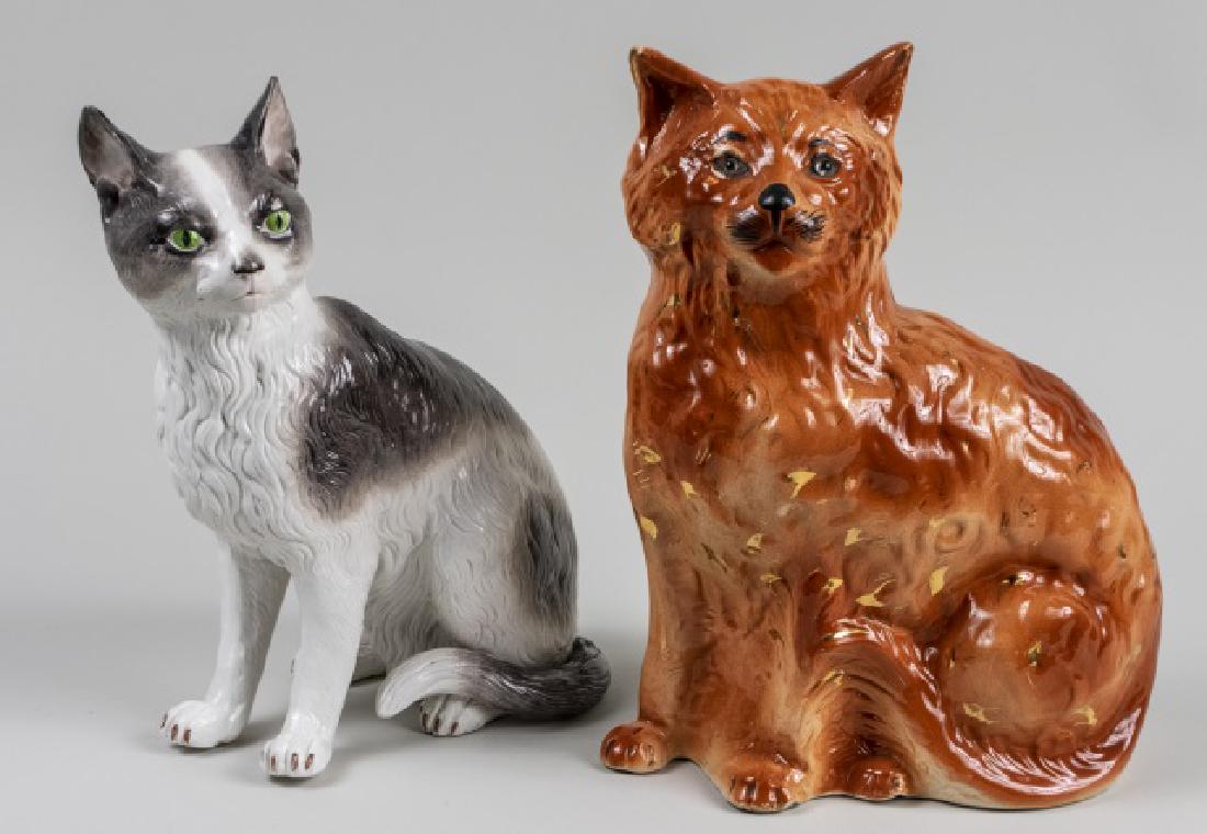 Two Ceramic Cat Figures: Black and white cat and a ginger cat. Taller, height 13 inches. Notice to bidders: Condition reports and additional photographs are provided by request as a courtesy to our clients, as such any condit