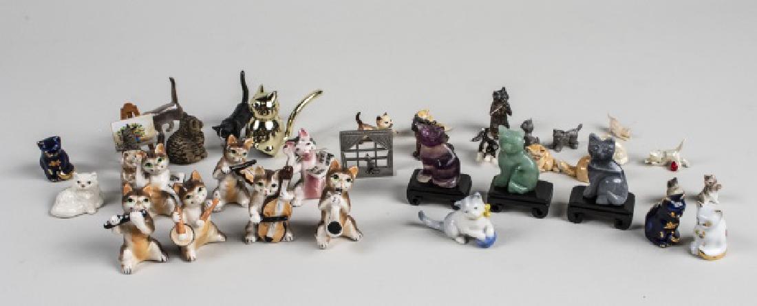 Group of Miniature Cat Figurines: Various makers and styles, porcelain, carved hardstone, composite, pewter, examples. Various sizes. Notice to bidders: Condition reports and additional photographs are provided by request as a courtes