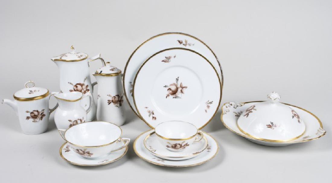 Royal Copenhagen Porcelain Dinner Service: Brown Rose pattern, #688, comprising five dinner plates, six luncheon plates, seven cream soup bowls with six underplates, eight cups and saucers, six bread plates, five small underplates, tureen, cof