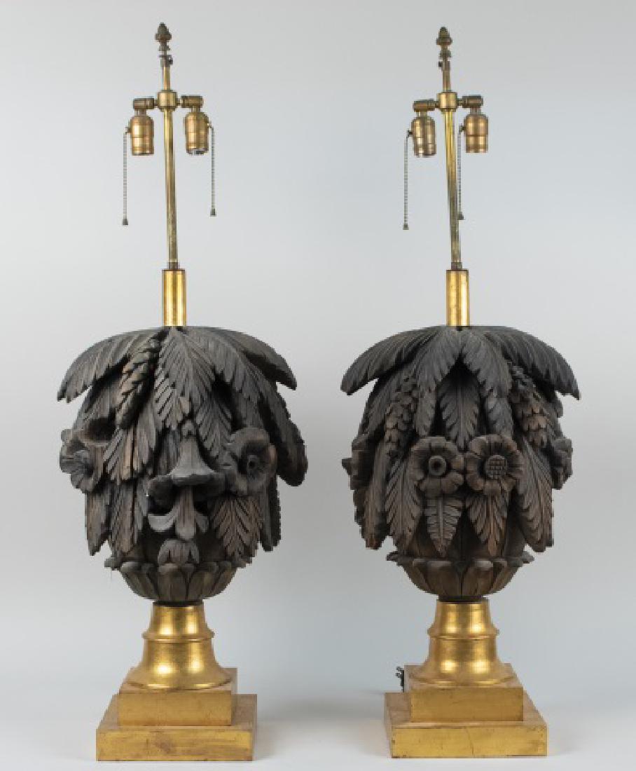 Pair of Carved Wood Floriform Lamps: Two light lamps, carved as palm leaves and flowers. Base, height 24 inches. Notice to bidders: Condition reports and additional photographs are provided by request as a courtesy to our clients, as suc