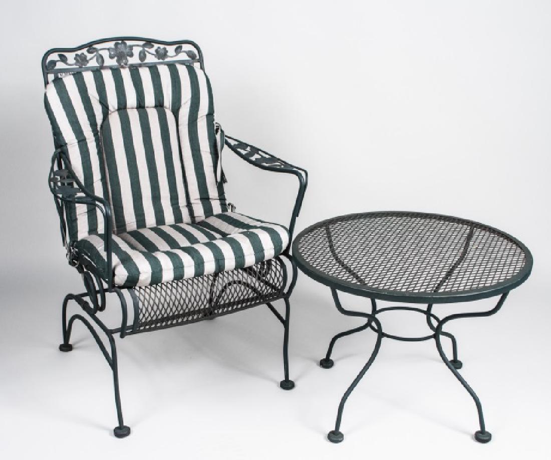 Iron Outdoor Table and Chair Set: Open arm garden chair with cushions and a circular table. Chair, height 38 inches, width 25 inches, depth 26 inches. Notice to bidders: Condition reports and additional photographs are provided by req