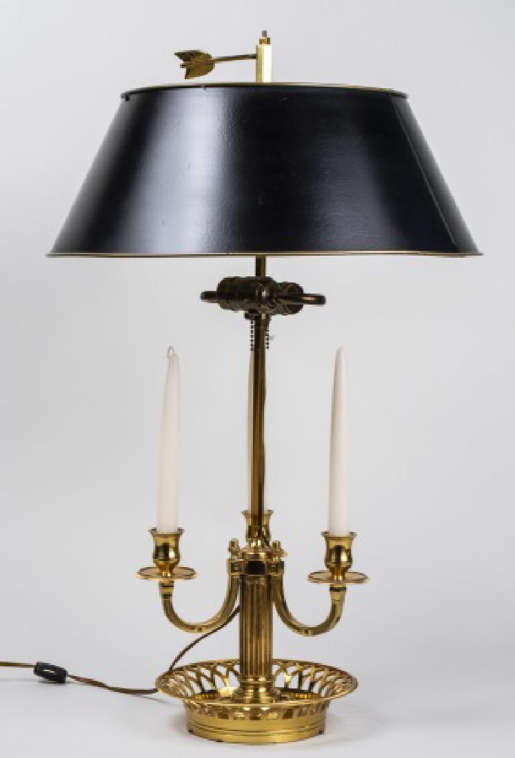 Brass Bouillotte Lamp: Two light lamp with black tole shade. Height 26 1/2 inches. Notice to bidders: Condition reports and additional photographs are provided by request as a courtesy to our clients, as such any condition 