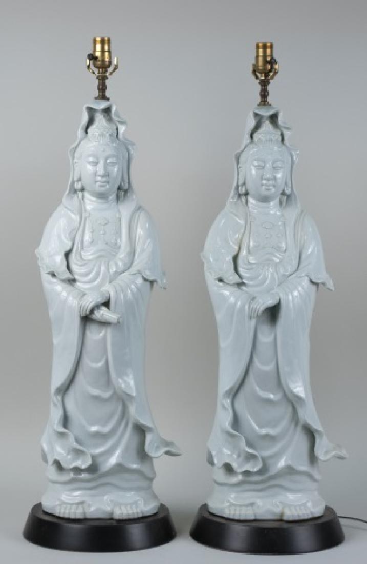 Pair of Blanc de Chine Guanyin Table Lamps: Single light figural lamps, the figures modelled standing with hands folded in front. Figures, height 30 inches. Notice to bidders: Condition reports and additional photographs are provided by request