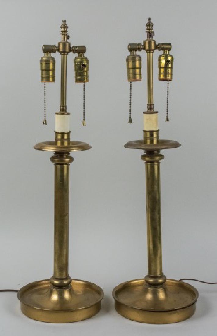 Pair of Brass Candlestick Lamps: Two light columnar lamps with circular bases. Base, height 20 inches. Notice to bidders: Condition reports and additional photographs are provided by request as a courtesy to our clients, as such any 