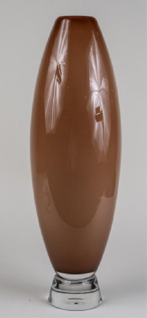 Abby Modell Art Glass Edamame Vase *: Chocolate brown ovoid body on a clear spread foot Height 24 inches Notice to bidders: Condition reports and additional photographs are provided by request as a courtesy to our clients, as such any con