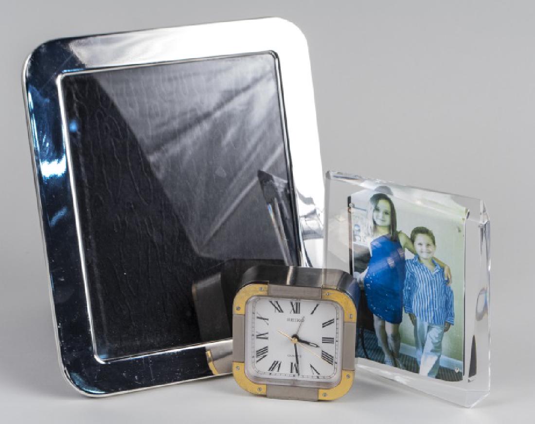 Seiko Desk Clock & Two Picture Frames: Larger frame holds an 8 x 10 photo Notice to bidders: Condition reports and additional photographs are provided by request as a courtesy to our clients, as such any condition report is only an opinion
