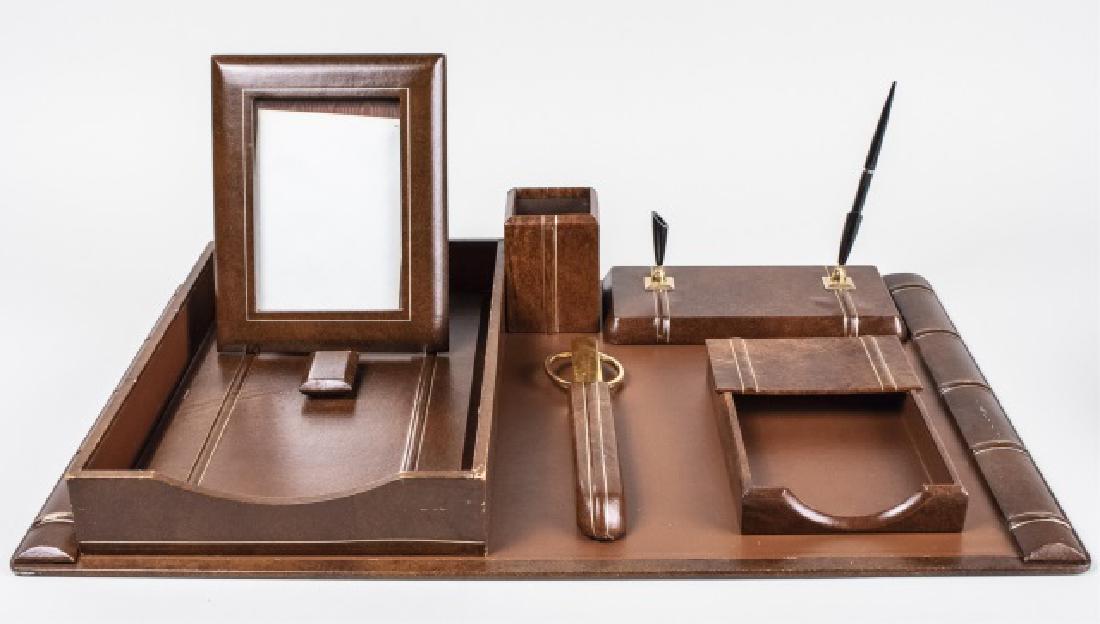 Leather Desk Set: Including a blotter, letter tray, note paper tray, desk pen, pencil holder, letter opener and scissors, etc Blotter, 27 x 18 inches Notice to bidders: Condition reports and additional photographs are 