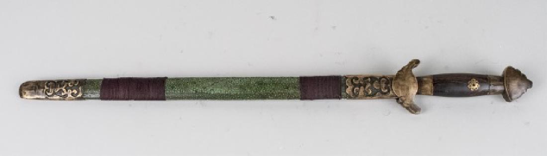 Chinese Seven Star Jian Sword: The double edged straight blade with brass inlaid seven star decoration, the wooden grip with antiqued brass guard and pommel, the green shagreen scabbard with matching antiqued brass fittings and cor