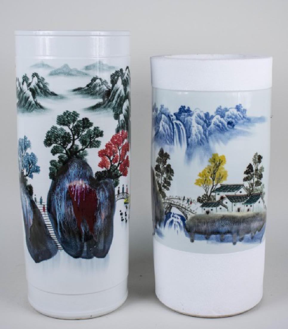 Two Chinese Porcelain Umbrella Stands: One with mountain landscape and another decorated with boats on a lake Taller, height 24 inches Notice to bidders: Condition reports and additional photographs are provided by request as a courtesy to