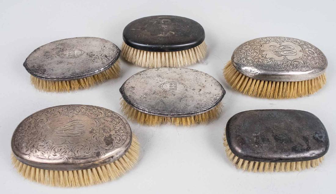 Five Sterling Silver Dresser Brushes: Various makers and styles. Provenance: From the Estate of Robert Sauers of New York and Philadelphia. Notice to bidders: Condition reports and additional photographs are provided by request as a court
