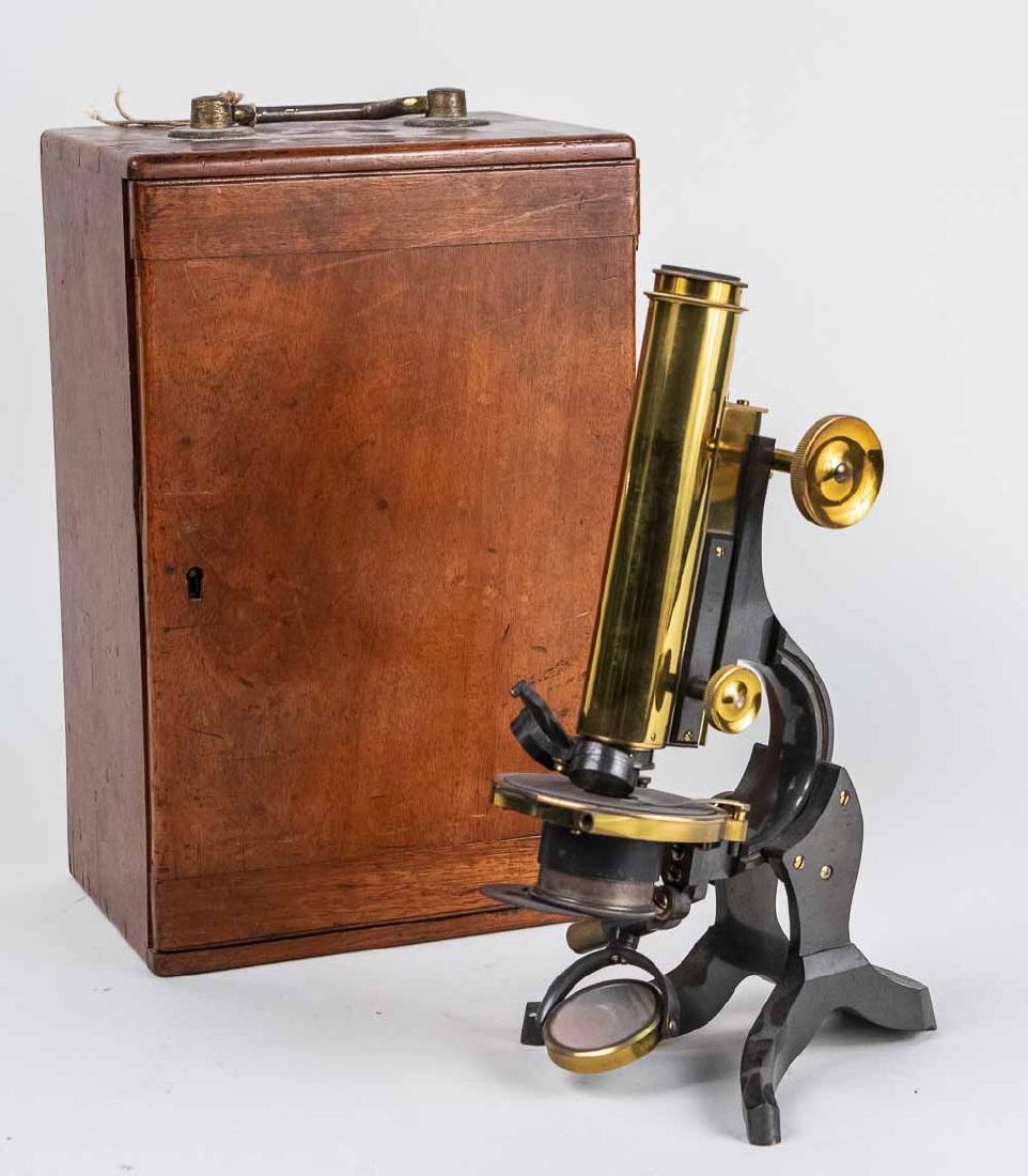 Swift & Son Microscope: Lacquered brass and patinated metal, stamped Swift & Son, 81 Tottenham Court Rd., London W.C. on base, in wood storage box. Notice to bidders: Condition reports and additional photographs are provided