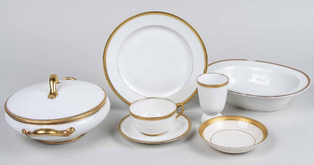 Limoges Porcelain Partial Dinner Set: Approximately fifty six pieces, white with gold rim, comprising twelve luncheon plates, nine salad plates, seven bread plates, seven bowls, two fruit bowls, four cups, ten saucers, five egg cups, a co