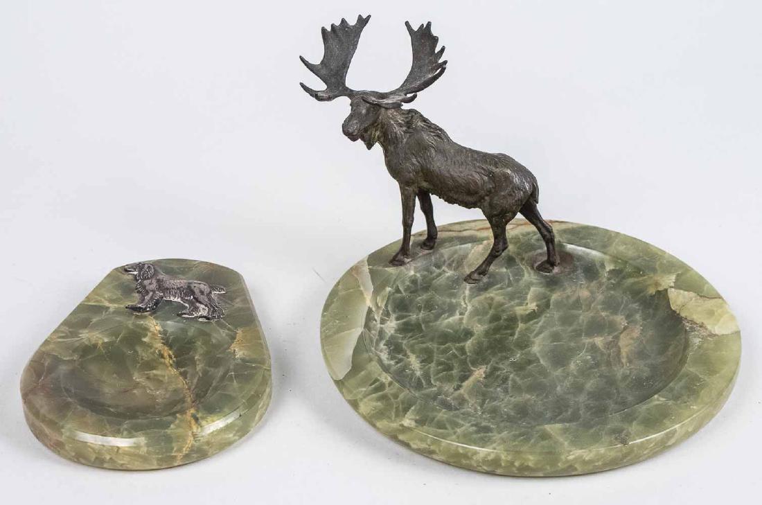 Two Onyx Dresser Trays: One mounted with a moose, the other a dog. Moose tray, height 5 inches, diameter 8 inches. Provenance: From the Estate of Robert Sauers of New York and Philadelphia. Notice to bidders: Condition repor