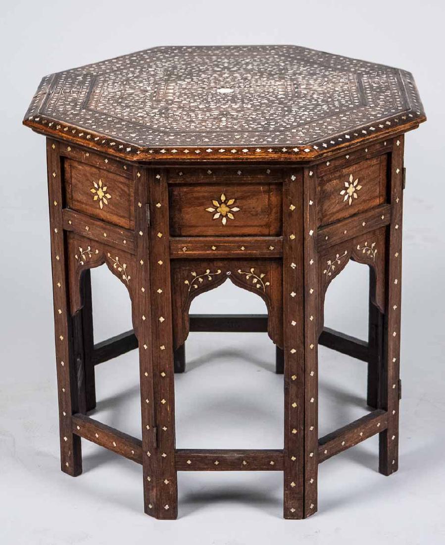 Syrian Table: Octagonal top with inlaid decoration. Height 18 inches, 18 inches square. Notice to bidders: Condition reports and additional photographs are provided by request as a courtesy to our clients, as such 