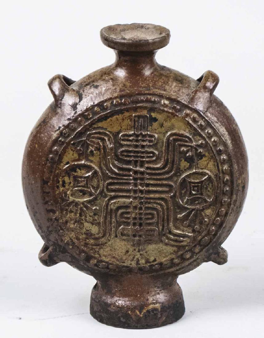 Chinese Pottery Moon Flask Vase: Raised stylized geometric decoration. Height 9 3/4 inches. Notice to bidders: Condition reports and additional photographs are provided by request as a courtesy to our clients, as such any condition r