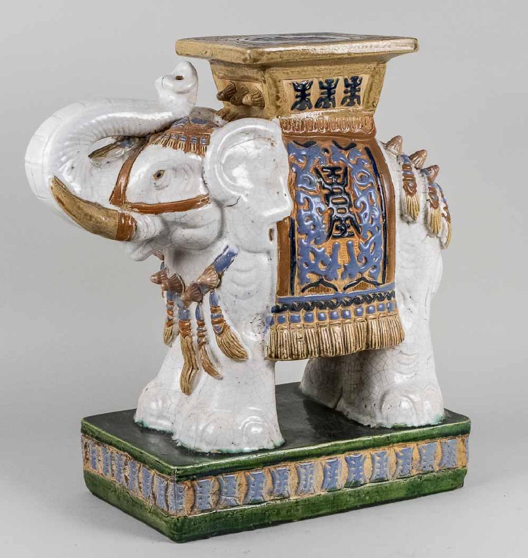 Chinese Ceramic Elephant Garden Seat: White elephant with polychrome decorated saddle seat. Height 21 inches. Notice to bidders: Condition reports and additional photographs are provided by request as a courtesy to our clients, as such an