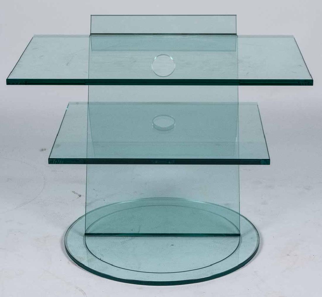 Contemporary Glass TV Stand: Three graduated shelves, on a circular base. Height 21 width 28 inches, depth 21 inches. Notice to bidders: Condition reports and additional photographs are provided by request as a courtesy to our cl