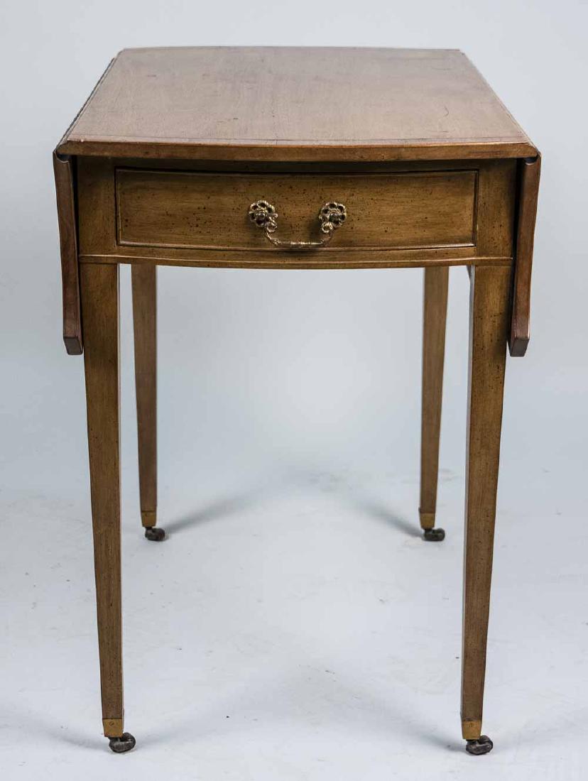 Pembroke Table: Georgian style with drop leaf top over a drawer, tapered square legs ending in brass casters. Closed, height 28 inches, width 19 1/4 inches, depth 30 inches. Notice to bidders: Condition reports and a