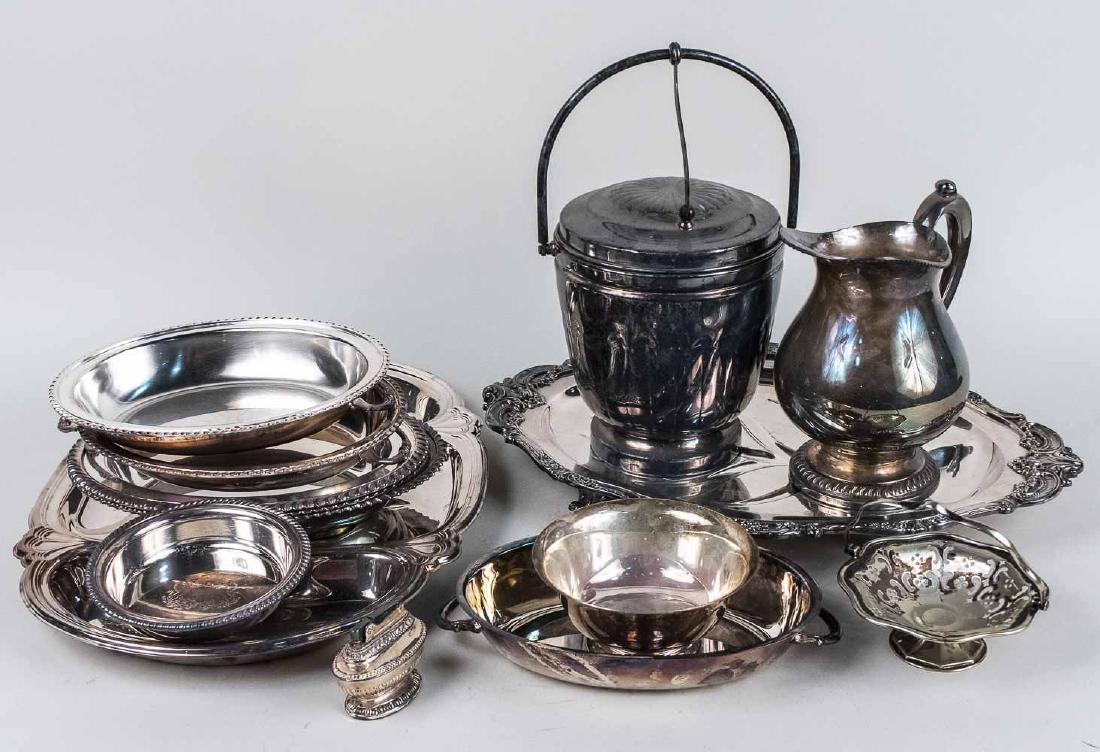 Group of Silver Plated Table Articles: Two well and tree serving trays, ice bucket, three covered entree dishes, basket, etc. Largest tray, length 20 inches. Notice to bidders: Condition reports and additional photographs are provided by r