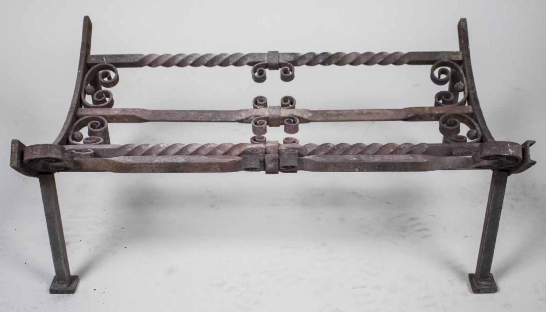 Wrought Iron Firewood Caddy: Crafted from a gate remnant, twist and scroll decoration. Height 12 inches, width 22 inches, depth 28 inches. Notice to bidders: Condition reports and additional photographs are provided by request as