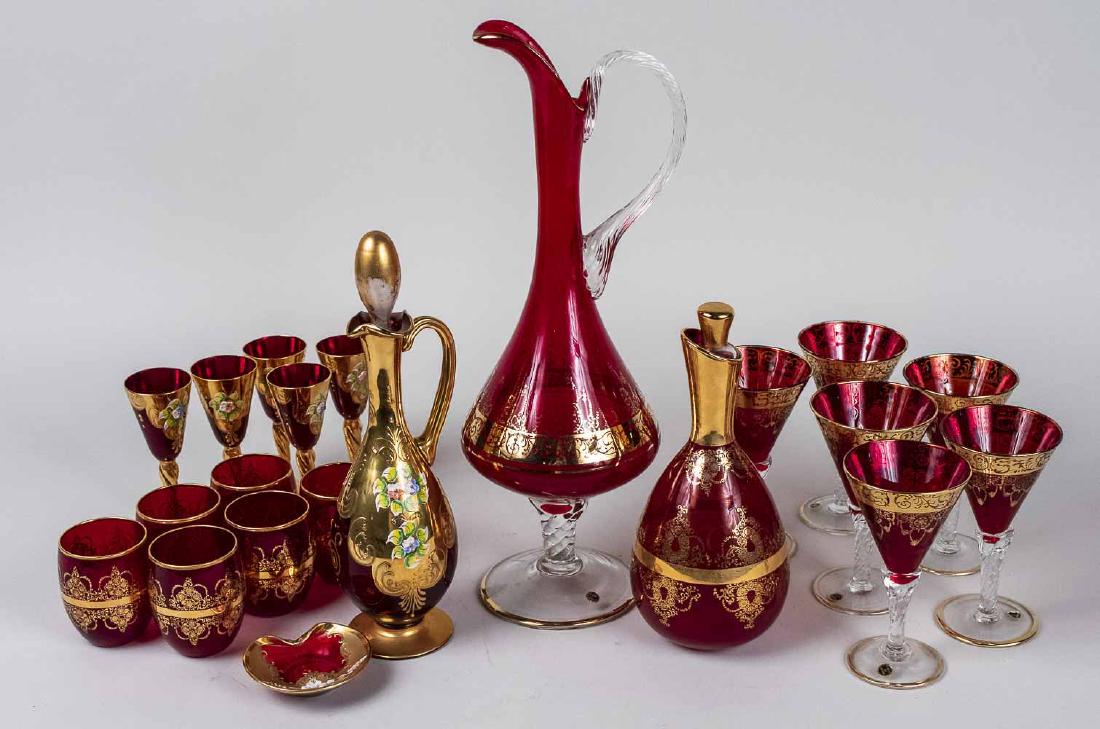 Group of Red Glass Table Articles: Including two ewers, a decanter and assorted stemware and barware. Tallest, height 16 3/4 inches. Notice to bidders: Condition reports and additional photographs are provided by request as a courtesy 